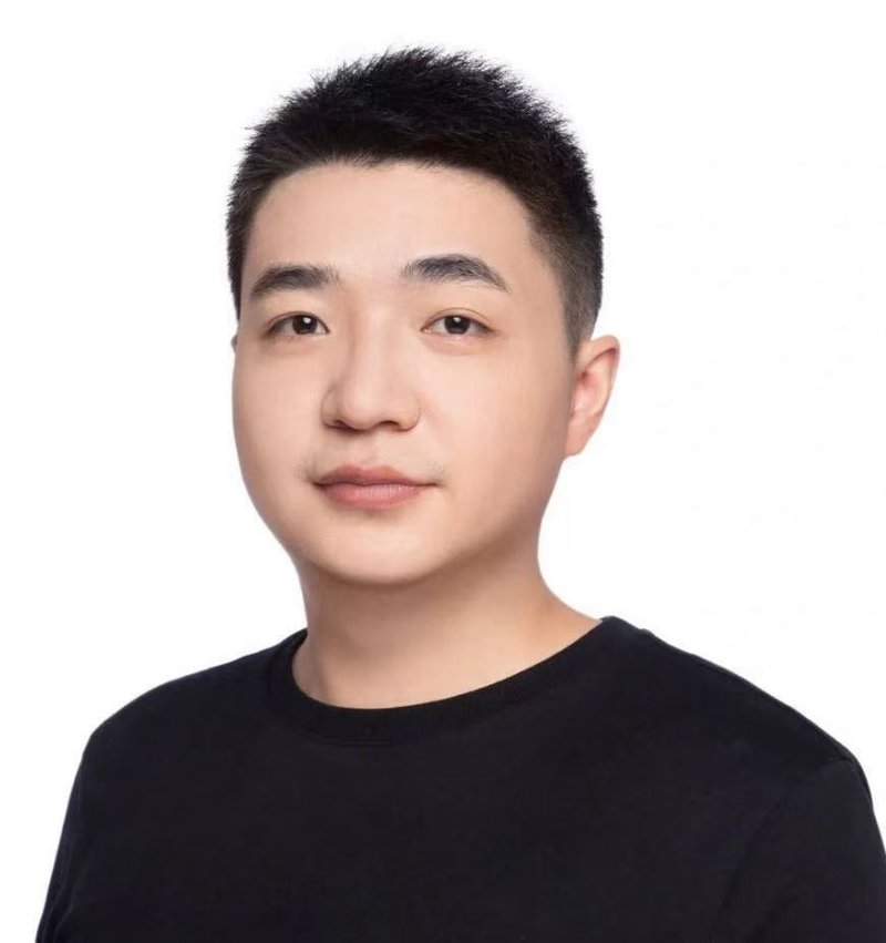 Head and shoulders portrait of Evan Ye in a black t-shirt against a white background